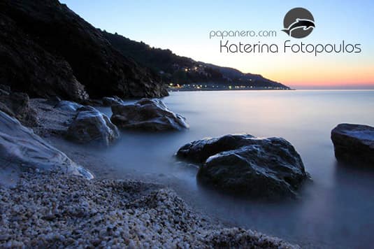 Papa Nero beach at dusk with the village lights along the shore