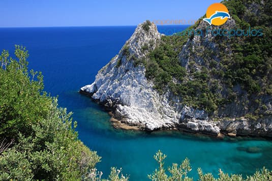 A white rock headland dropping into turquoise water
