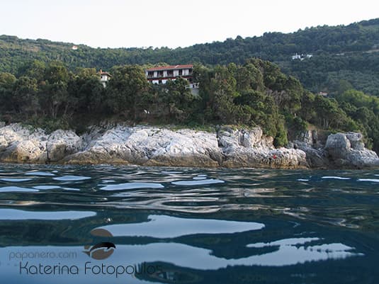 The house standing above the rocks at Papa Nero, seen from the water